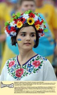 DONETSK, JUNE 15, 2012. A Ukraina fan with a painted face, in traditional Ukraina dress, before a Euro 2012 football match.  RE1013B5