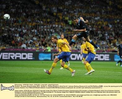 Football - European Championships 2012 - Sweden vs. England England s Andy Carroll - between Andreas Granqvist (L) and Olof Mellberg (SWE) - scores the opening goal at the Olympic Stadium, Kiev 