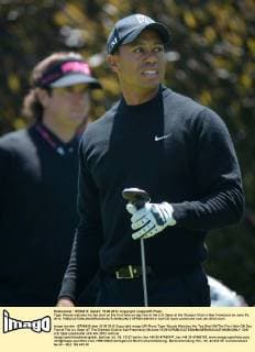 Tiger Woods watches his tee shot on the first hole on day two of the U.S. Open at the Olympic Club in San Francisco on June 15, 2012.  SFP2012061514