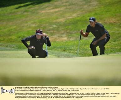Bubba Watson (L) and Tiger Woods line up their putts on the third green on day two of the U.S. Open at the Olympic Club in San Francisco on June 15, 2012.  SFP2012061520