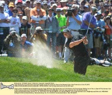 Tiger Woods hits out of the sand to the fourth green on day two of the U.S. Open at the Olympic Club in San Francisco on June 15, 2012.  SFP2012061521