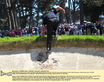 Tiger Woods climbs out of a bunker on the 6th hole during round two of the 112th U.S. Open at the Olympic Club in San Francisco, California on June 15, 2012.  SFP20120615328