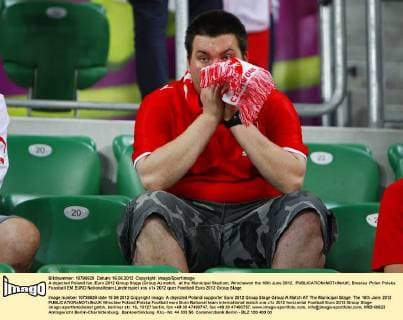 A dejected Poland fan..Euro 2012 Group Stage (Group A) match, at the Municipal Stadium, Wroclawon the 16th June 2012. EDITORIAL USE ONLY. No use with unauthorised audio, video, data, fixture lists, club league logos or live services. Online in-match use limited to 120 images, no video emulation. No use in betting, games or single club league player publications.