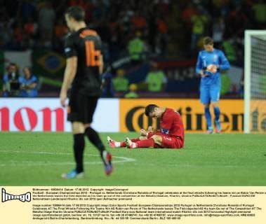 Football - European Championships 2012 - Portugal vs. Netherlands Christiano Ronaldo of Portugal celebrates at the final whistle following his teams win as Robin Van Persie of the Netherlands leaves the field dejected as his team go out of the competition at the Metalist Stadium, Kharkiv, Ukraine 