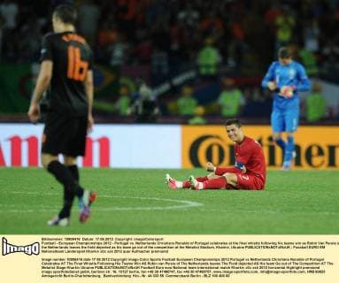 Football - European Championships 2012 - Portugal vs. Netherlands Christiano Ronaldo of Portugal celebrates at the final whistle following his teams win as Robin Van Persie of the Netherlands leaves the field dejected as his team go out of the competition at the Metalist Stadium, Kharkiv, Ukraine 