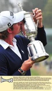 Webb Simpson kisses the U.S. Open Trophy after winning the 112th U.S. Open at the Olympic Club in San Francisco, California on June 17, 2012. Simpson finished one-over-par with a four day combined total of 281.  SFP20120617125