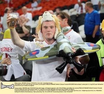 An England fan with a pint off beer and a blow up aeroplane EDITORIAL USE ONLY. No use with unauthorised audio, video, data, fixture lists, club league logos or live services. Online in-match use limited to 120 images, no video emulation. No use in betting, games or single club league player publications.