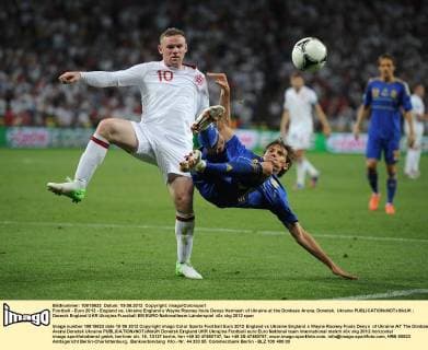 Football - Euro 2012 - England vs. Ukraine England s Wayne Rooney fouls Denys Harmash of Ukraine at the Donbass Arena, Donetsk, Ukraine 