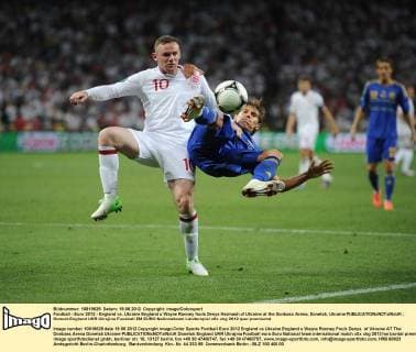 Football - Euro 2012 - England vs. Ukraine England s Wayne Rooney fouls Denys Harmash of Ukraine at the Donbass Arena, Donetsk, Ukraine 
