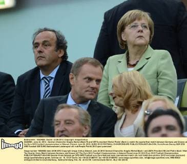 GDANSK, June 22, 2012 - German Chancellor Angela Merkel (Back R) and UEFA president Michel Platini (Back L) watch the quarterfinal match between Germany and Greece at the Euro 2012 football championships in Gdansk, Poland, June 22, 2012. EURO 2012 FOOTBALL CHAMPIONSHIPS 