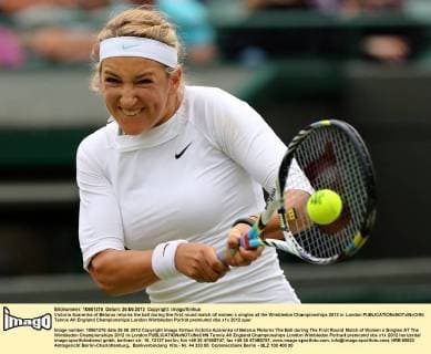 Victoria Azarenka of Belarus returns the ball during the first round match of women s singles at the Wimbledon Championships 2012 in London 