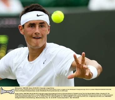 Bernard Tomic of Australia returns the ball during the first round match of men s singles at the Wimbledon Championships 2012 in London 