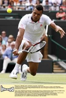 Jo-Wilfried Tsonga of France returns the ball during the first round match of men s singles at the Wimbledon Championships 2012 in London 