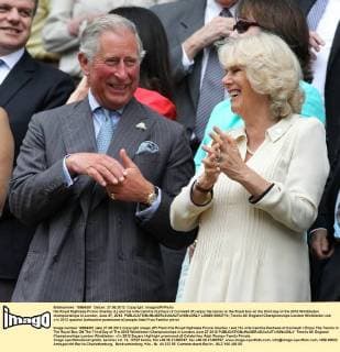 His Royal Highness Prince Charles (L) and his wife Camilla Duchess of Cornwall (R) enjoy the tennis in the Royal box on the third day of the 2012 Wimbledon championships in London, June 27, 2012.  LON2012062713