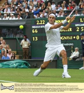 Swiss Roger Federer returns in his match on the third day of the 2012 Wimbledon championships in London, June 27, 2012.  LON2012062721