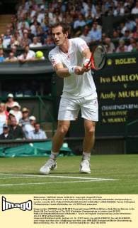 Britain s Andy Murray returns in his match on the fourth day of the 2012 Wimbledon championships in London, June 28, 2012.  LON2012062829