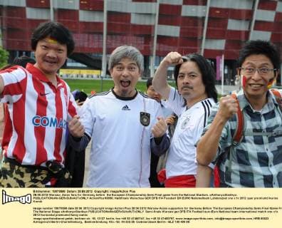 28.06.2012 Warsaw. Asian fans for Germany before the European Championship Semi Final game from the National Stadium. xAnthonyxStanleyx  ActionPlus18056