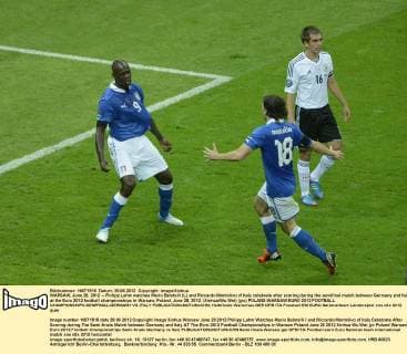 WARSAW, June 28, 2012 -- Philipp Lahm watches Mario Balotelli (L) and Riccardo Montolivo of Italy celebrate after scoring during the semifinal match between Germany and Italy at the Euro 2012 football championships in Warsaw, Poland, June 28, 2012. (Xinhua Wu Wei) (jyc) POLAND-WARSAW-EURO 2012 FOOTBALL CHAMPIONSHIPS-SEMIFINAL-GERMANY VS ITALY 