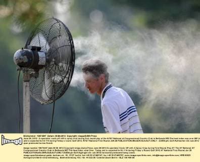 June 28, 2012 - A spectator cools off with a spray mist during first round play at the AT&T National at Congressional Country Club in Bethesda MD.The heat index was over 90F today and is expected to hit 114 during Friday s round. Golf 2012: AT&T National First Round JUN 28 - ZUMAcjm
