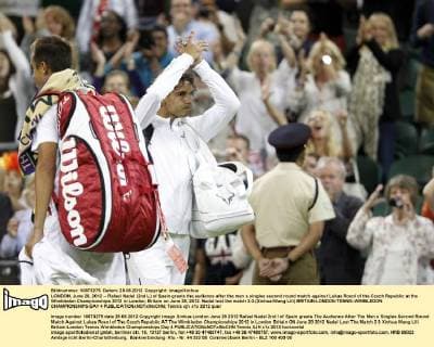 LONDON, June 28, 2012 -- Rafael Nadal (2nd L) of Spain greets the audience after the men s singles second round match against Lukas Rosol of the Czech Republic at the Wimbledon Championships 2012 in London, Britain on June 28, 2012. Nadal lost the match 2-3.(Xinhua Wang Lili) BRITAIN-LONDON-TENNIS-WIMBLEDON CHAMPIONSHIPS-DAY 4 