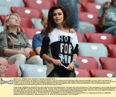 Polish model Natalia Siwiec, the hottest girl of Euro 2012 shows a T-shirt that reads at the front Bad Boy Cambell and at the back BBC is to mock former international Sol Campbell’s comments about the dangers of travelling to Poland and Ukraine, during The Euro 2012 football championships semi-final match Germany vs. Italy on June 28, 2012 at the National Arena in Warsaw, Poland.  EN_01032216_0296