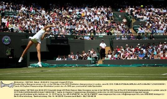 Russian Maria Sharapova serves in her on the fifth day of the 2012 Wimbledon championships in London, June 29, 2012.  LON2012062901
