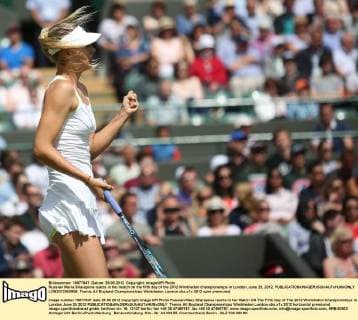 Russian Maria Sharapova reacts in her match on the fifth day of the 2012 Wimbledon championships in London, June 29, 2012.  LON2012062908