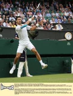 Serbian Novak Djokovic returns in his match on the fifth day of the 2012 Wimbledon championships in London, June 29, 2012.  LON2012062913