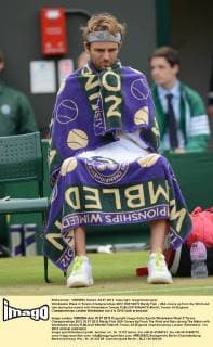 Wimbledon Week 2; Tennis Championships 2012 03 07 2012 Mardy Fish - USA covers up from the Wind and rain during the match with Wimbledon Towels 