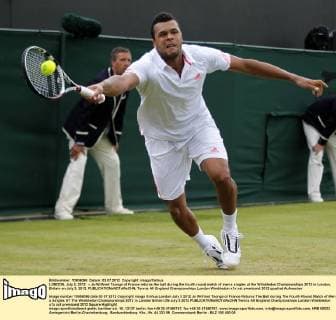 LONDON, July 3, 2012 -- Jo-Wilfried Tsonga of France returns the ball during the fourth round match of men s singles at the Wimbledon Championships 2012 in London, Britain on July 3, 2012. 