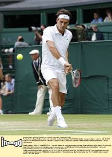 Switzerland s Roger Federer returns in his match on the ninth day of the 2012 Wimbledon championships in London, July 4, 2012.  LON2012070416