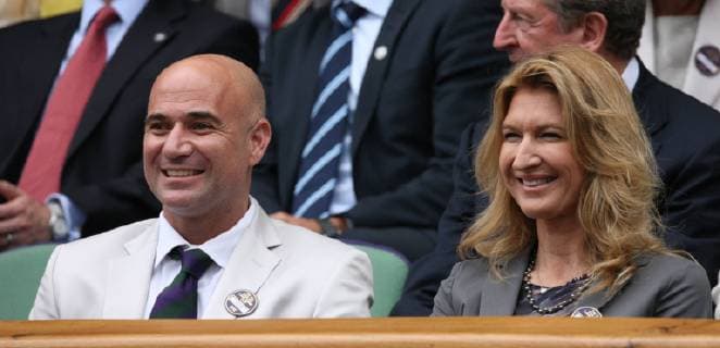 Andre Agassi and his wife Steffi Graf enjoy the tennis in the Royal box on the ninth day of the 2012 Wimbledon championships in London, July 4, 2012.  LON2012070419