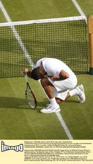 Jo-Wilfried Tsonga of France gestures during the quarterfinal of men s singles at the Wimbledon Championships 2012 in London - 