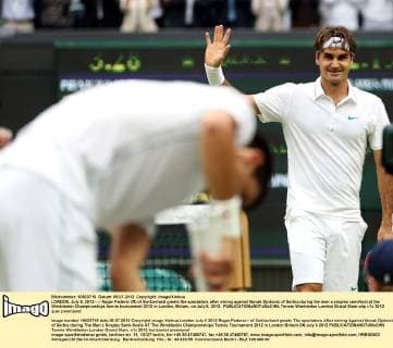 LONDON, July 6, 2012 - -- Roger Federer (R) of Switzerland greets the spectators after wining against Novak Djokovic of Serbia during the men s singles semifinal at the Wimbledon Championships tennis tournament 2012 in London, Britain, on July 6, 2012. 