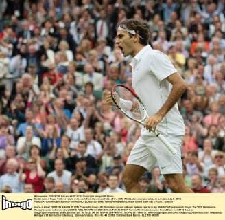 Switzerland s Roger Federer reacts in his match on the eleventh day of the 2012 Wimbledon championships in London, July 6, 2012.  LON2012070698