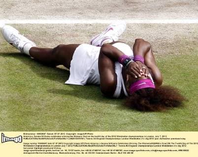 America s Serena Williams celebrates winning the Womens final on the twelth day of the 2012 Wimbledon championships in London, July 7, 2012.  LON2012070701r