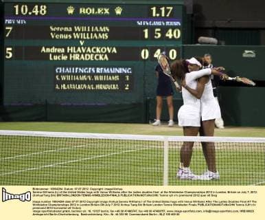 Serena Williams (L) of the United States hugs with Venus Williams after the ladies doubles final at the Wimbledon Championships 2012 in London, Britain on July 7, 2012. (Xinhua Tang Shi) BRITAIN-LONDON-TENNIS-WIMBLEDON-FINALS 