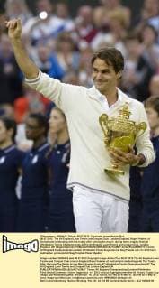 08.07.2012. The All England Lawn Tennis and Croquet Club. London, England. Roger Federer of Switzerland celebrating with the trophy after winning the match during mens singles finals at Wimbledon Tennis Championships at The All England Lawn Tennis and Croquet Club. London, England, UK xNigelxWaldronx  ActionPlus20255771