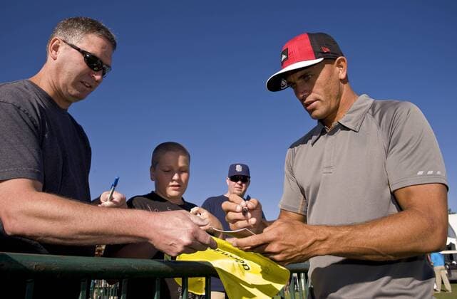 July 21, 2012 - Stateline, Nevada, USA - Professional surfer Kelly Slater signs autographs before heading to the teeing grounds during the 22nd annual American Century Championships at the Edgewood Tahoe Golf Course. The made-for-tv ACC, owned and broadcast by NBC Sports, is the world s premier celebrity golf tournament. American Century Championship - 2012 Saturday - ZUMAce6