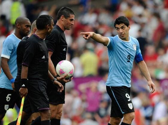 Uruguay s Luis Suarez remonstrates with the officials at half time in the UAE v Uruguay Olympic Group A match at Old Trafford, Manchester United Kingdom on the 26th July 2012..Pic Simon Bellis SPORTIMAGE. EDITORIAL USE ONLY. No use with unauthorised audio, video, data, fixture lists, club league logos or live services. Online in-match use limited to 120 images, no video emulation. No use in betting, games or single club league player publications.