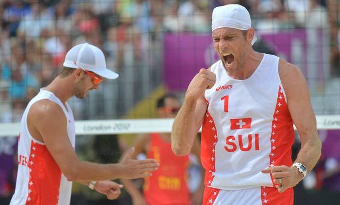 (120728) -- LONDON, July 28, 2012 (Xinhua) -- Sebastian Chevallier (L) and Sascha Heyer of Switzerland celebrate victory during the men s preliminary phase beach volleyball match at the London 2012 Olympic Games in London, Britain, July 28, 2012. 
