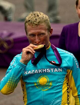 LONDON, July 28, 2012 - Alexandr Vinokurov of Kazakhstan bites the gold medal at the awarding ceremony of the men s road race event of cycling at the London 2012 Olympic Games in London, Britain, July 28, 2012. Alexandr Vinokurov claimed the title in this event with 5:45:57. 
