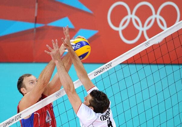 ITAR-TASS: LONDON, UK. JULY 29, 2012. Russia s Taras Khtei (L) making a dip during a preliminary round group B men s volleyball match against Germany at London 2012 Summer Olympic Games, at Earls Court. Russia won the game 3:0.  premiumd Highlight RE104307