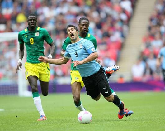 Senegals Abdoulaye Ba gets sent off for this tackle on Uruguays Luis Suarez ..London 2012 Olympic Games, Senegal v Uruguay, Wembley Stadium, London, 29th July 2012. Pic David Klein SPORTIMAGE... EDITORIAL USE ONLY. No use with unauthorised audio, video, data, fixture lists, club league logos or live services. Online in-match use limited to 120 images, no video emulation. No use in betting, games or single club league player publications.