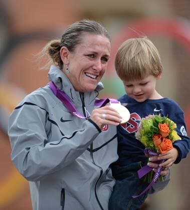 Goldmedalist Kristin Armstrong of the United States (USA) holds her son Lucas William Savola during victory ceremony of women s Cycling Road individual time trial contest, at London 2012 Olympic Games in London, Britain, on August 1, 2012. 