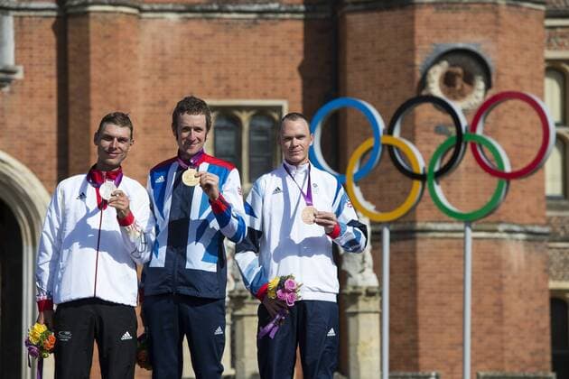 01.08.2012. Richmond, England. (L-R) Silver Medallist Germanys Tony Martin (GER), Gold Medallist Britains bradley Wiggins (GBR) and his team mate and Bronze Medallist Chris Froome (GBR) stand on the podium in front of the Palace after the Mens Cycling Time Trial on Day 5 of the London 2012 Olympic Games at Hampton Court Palace. xRoganxThomsonx  ActionPlus11310167