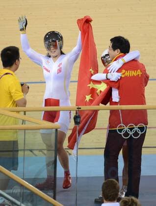 LONDON, Aug. 2, 2012 - Guo Shuang (2nd L) and Gong Jinjie of China celebrate after the women s team sprint final of cycling track event, at London 2012 Olympic Games in London, Britain, August 2, 2012. The Chinese team won the silver medal of the event. LONDON-CYCLING TRACK-WOMEN S TEAM SPRINT 