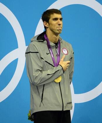 Michael Phelps of the United States listens to the USA National Anthem during the medal ceremony following the Men s 200m Individual Medley Final at the London 2012 Summer Olympics on August 2, 2012 in London. Phelps won the Gold Medal, finishing with a time of 1:54.27.  OLY20120802306