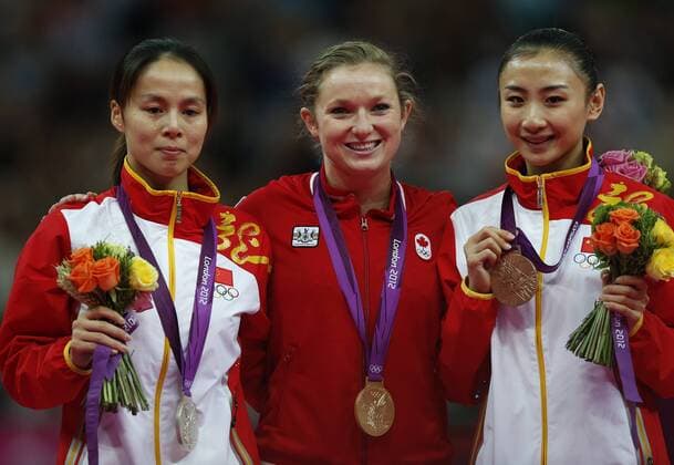 LONDON, Aug. 4, 2012 - Gold medalist Rosannagh Maclennan (C) of Canada, silver medalist Huang Shanshan (L) of China, bronze medalist He Wenna of China attend awarding ceremony of women s trampoline competition at the London 2012 Olympic Games in London, Britain, Aug. 4, 2012. 