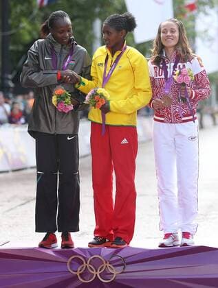 LONDON, Aug. 5, 2012 - Gold medalist Tiki Gelana (C) of Ethitopia, silver medalist Priscah Jeptoo (L) of Kenya, bronze medalist Tatyana Petrova Arkhipova of Russia attend awarding ceremony of women s marathon at London 2012 Olympic Games in London, Britain, August 5, 2012. 